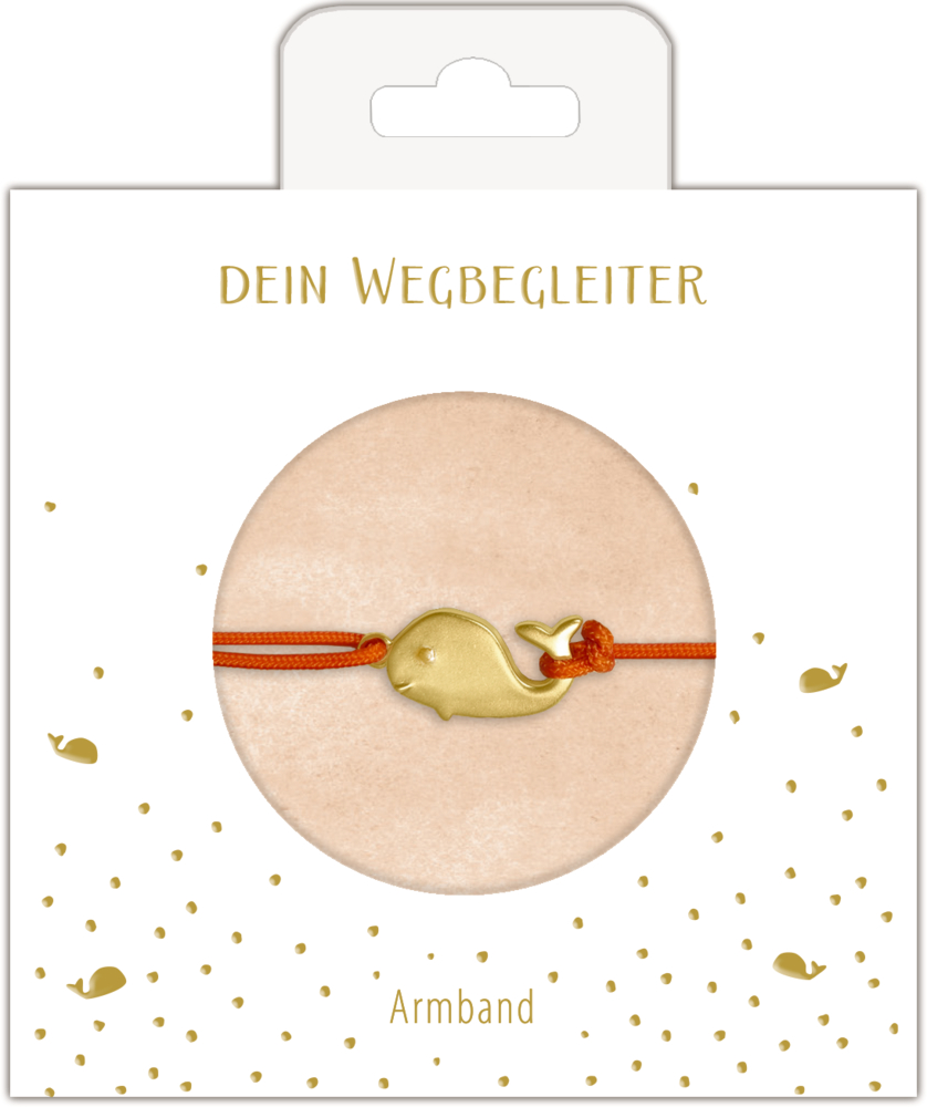 Goldener Wal-Anhänger am roten Armband, präsentiert auf Karte mit goldenen Punkten und  Text.