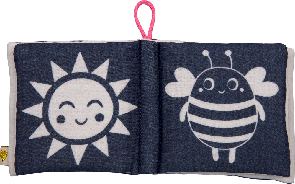 Stoffbuch mit schwarz-weiß-Abbildungen einer lächelnden Sonne und einer gestreiften Biene auf dunkelblauem Hintergrund.