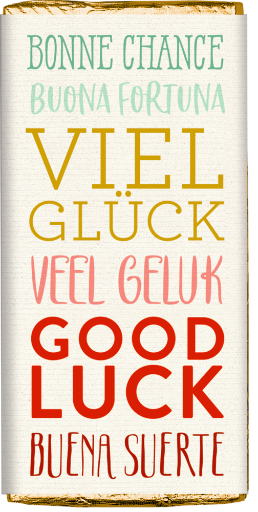 Schokoladentafel mit goldener Folie, Banderole mit der Aufschrift „Viel Glück“ in mehreren Sprachen unf Farben.
