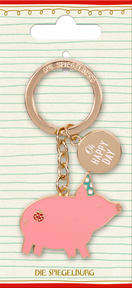 Schlüsselanhänger mit rosa Schwein, Partyhut und Marienkäfermotiv sowie rundem Anhänger mit Text „Oh Happy Day“ auf Pappkarte.