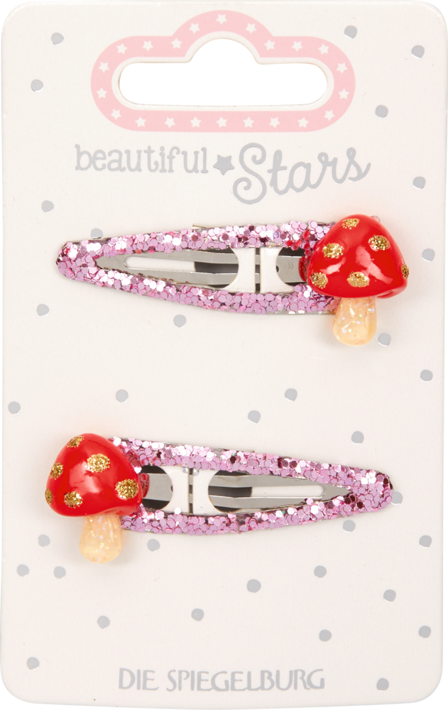 Ein Paar glitzernde rosa Haarspangen, jede mit einem rot-goldenen Pilz, präsentiert auf einer gepunkteten Karte.