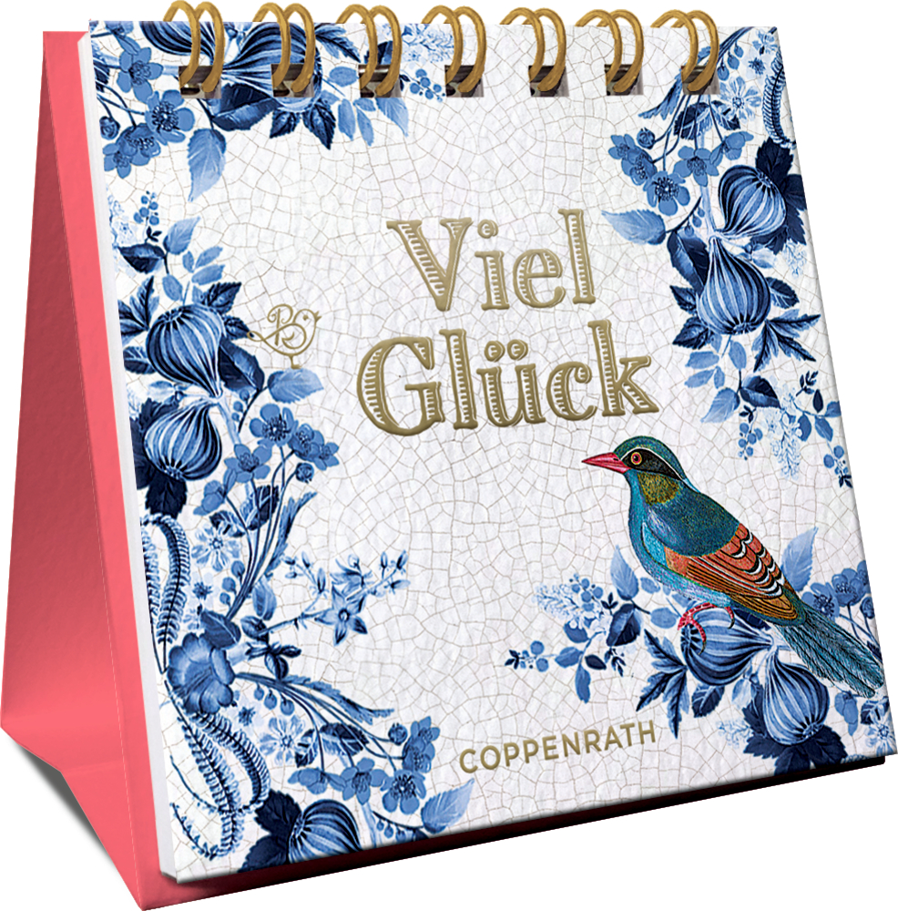 Blumiger Spiralaufsteller mit „Viel Glück“ und einem bunten Vogel auf weißem, blauem und rosa Hintergrund, in einer seitlichen Ansicht.
