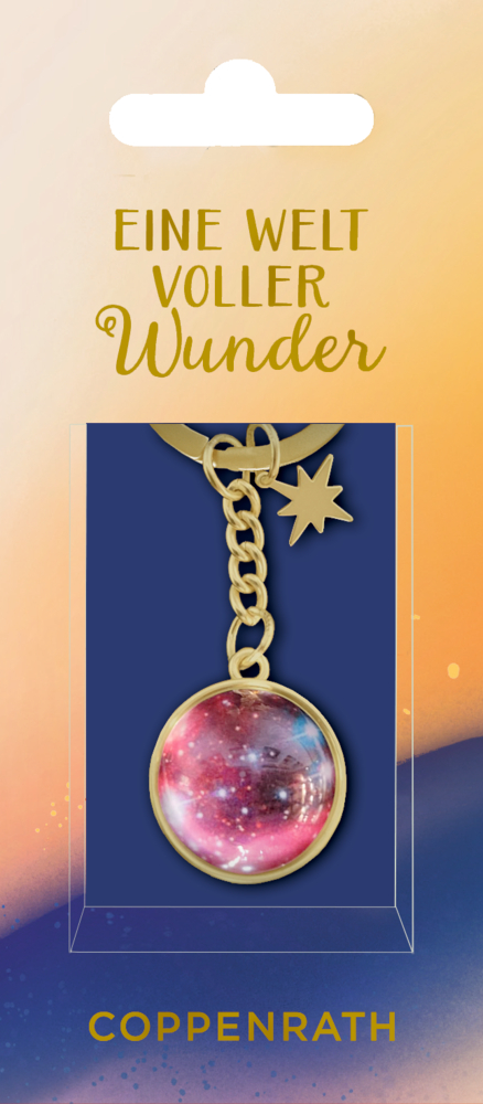 Goldener Schlüsselanhänger mit pinkem Galaxy-Anhänger und Stern-Charm auf Verpackung mit Aufschrift Eine Welt voller Wunder.