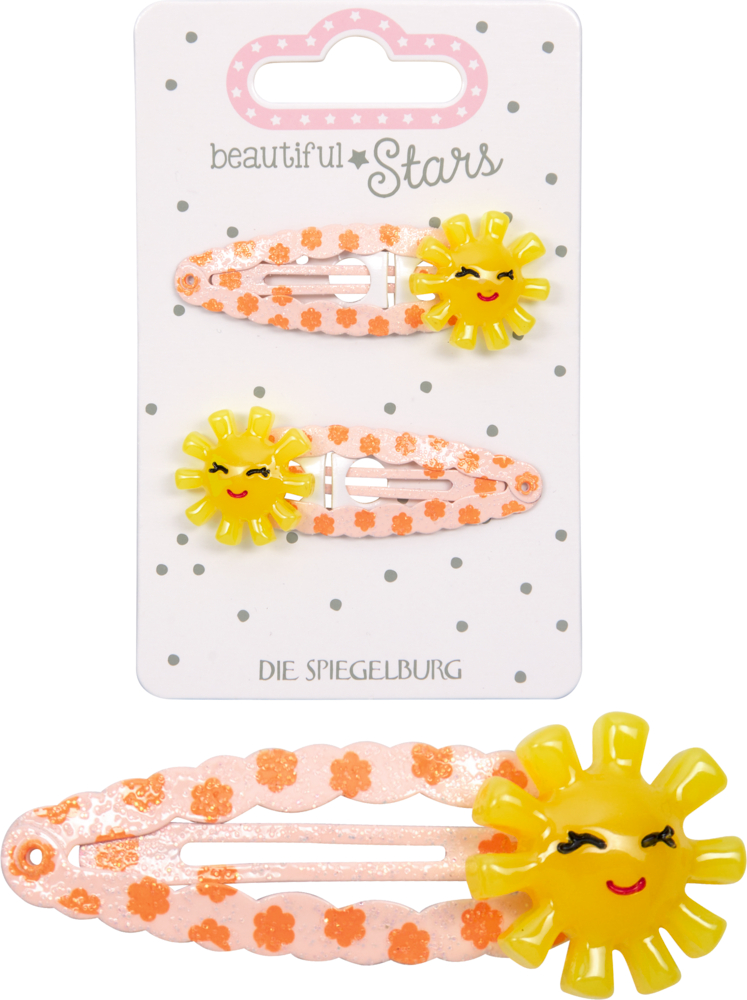 Zwei rosa Haarspangen mit orangefarbenen Blütenmustern und gelben Sonnenmotiven mit Gesicht, dadrüber diese zwei Haarspangen auf der Produktverpackung.