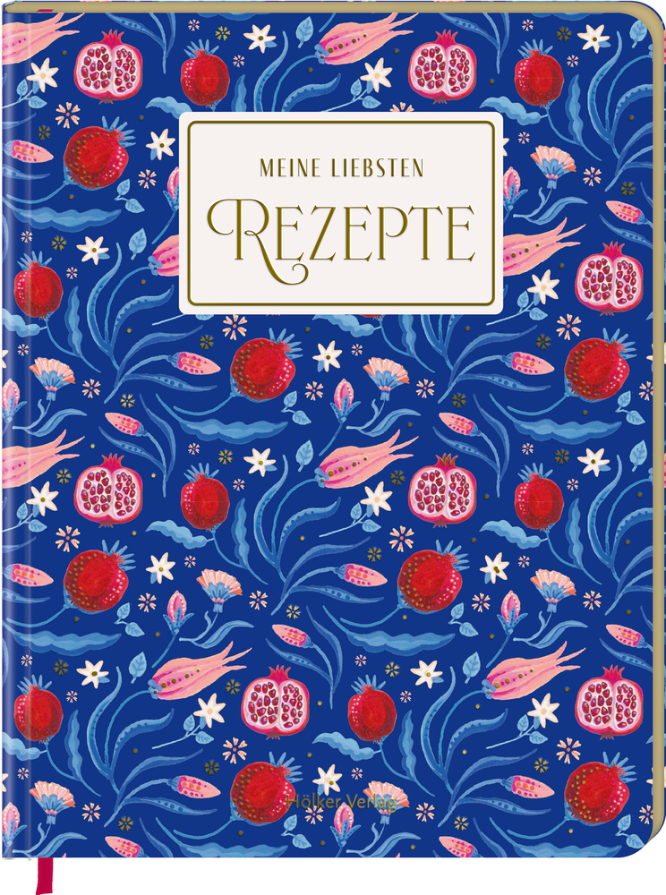 Notizbuch mit der Aufschrift „Meine liebsten Rezepte“ und blauem Umschlag mit Granatapfel- und Blumenmuster.