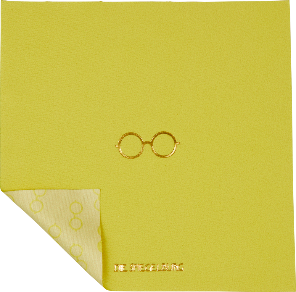 Gelbgrüner Stoff mit gefalteter Ecke und goldenem Brillensymbol.