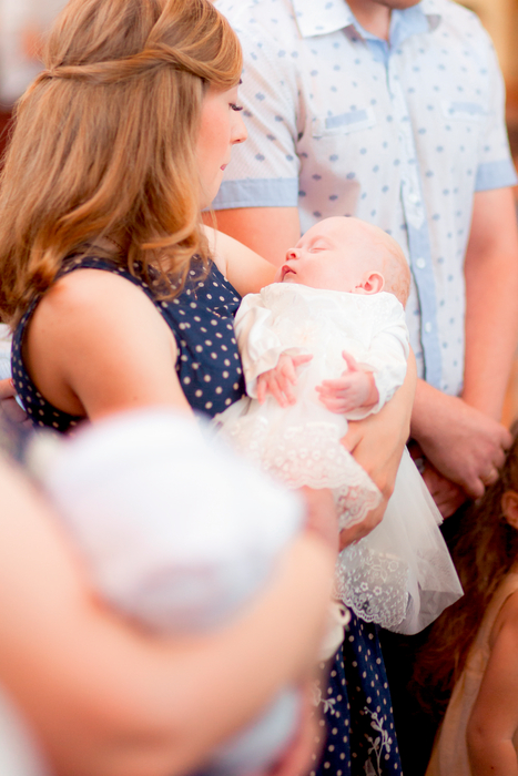 Mutter schaut liebevoll auf ihr auf ihrem Arm schlafendem Baby