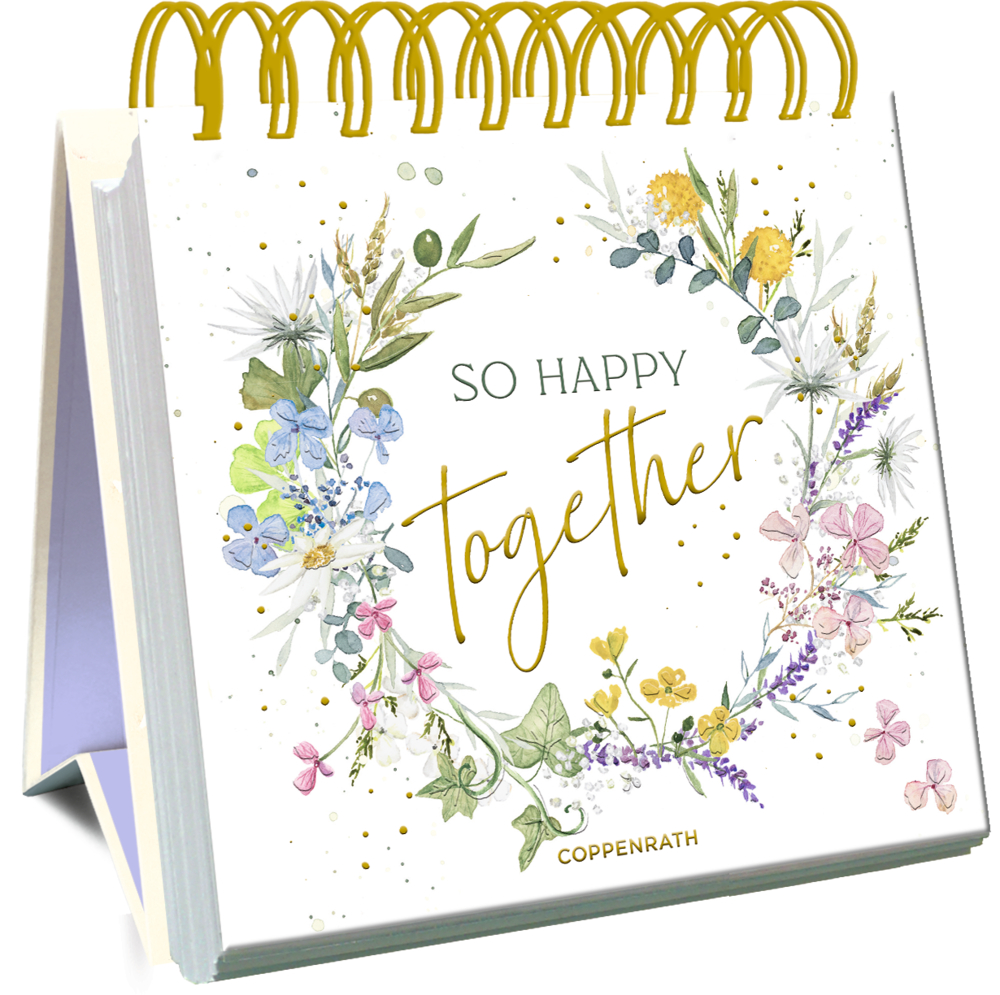 Spiralgebundener Tischkalender mit einem Blumenkranz und dem Spruch „So Happy Together“ auf dem Cover.