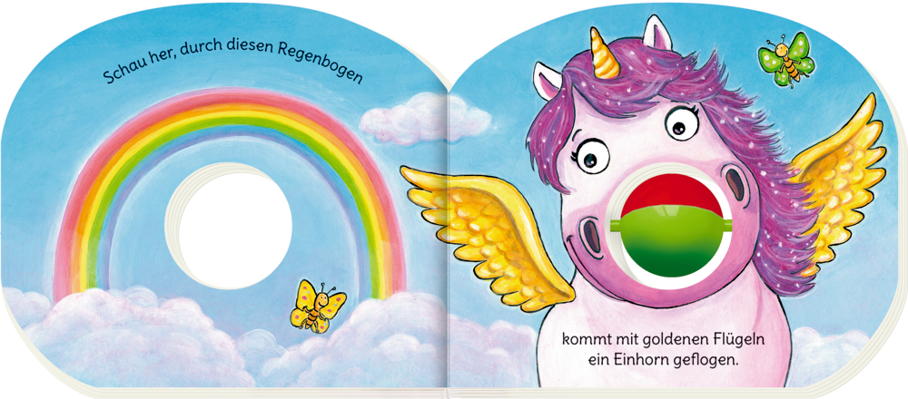 Ein lila Einhorn mit goldenen Flügeln und Kuller-Nase fliegt neben einem Regenbogen und Schmetterlingen in einem strahlend blauen Himmel, auf einer Innenansicht mit Text.