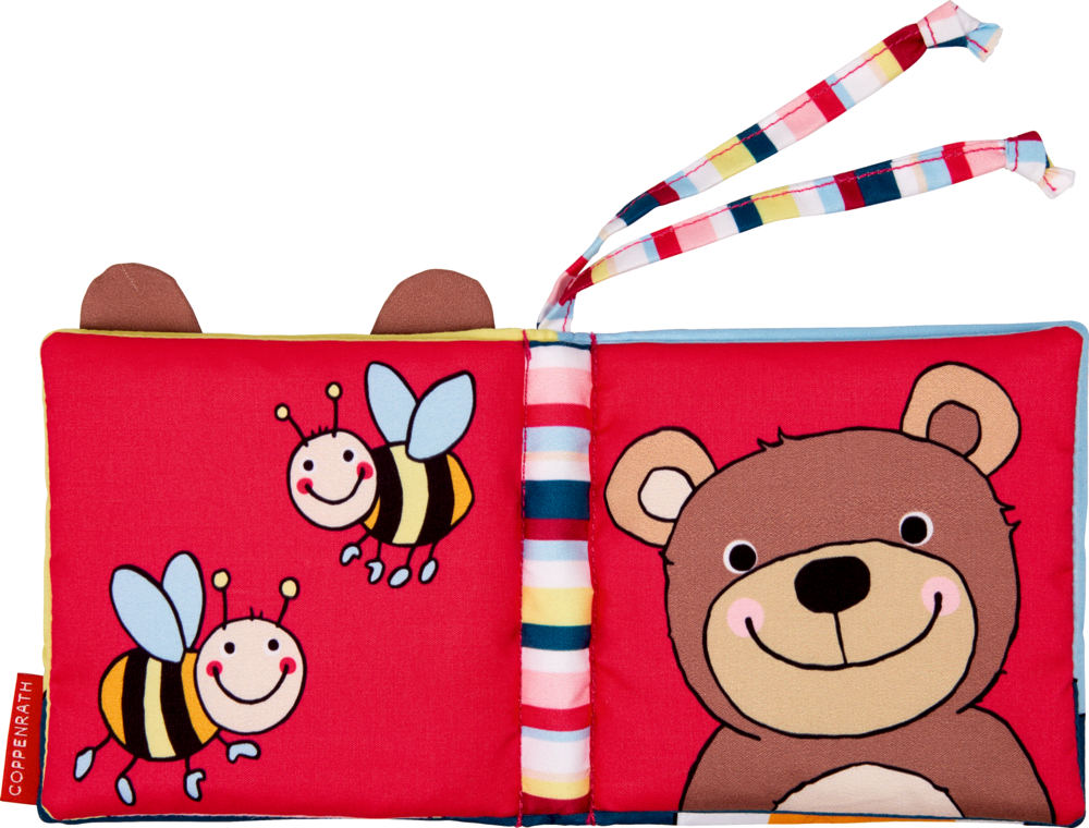 Babybuch aus Stoff mit Cartoon-Bienen auf der linken Seite und einem lächelnden Bären auf der rechten Seite.